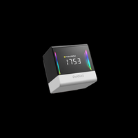 Digital temperature and humidity monitor with RGB lighting on a black background