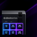 Steelseries gaming controller with illuminated buttons on a dark background