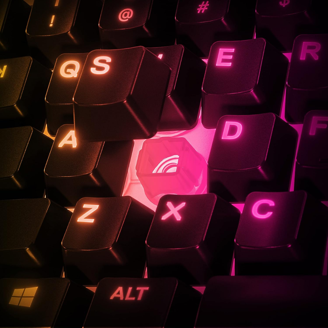 Close-up of a keyboard with glowing pink and orange letters on a dark background