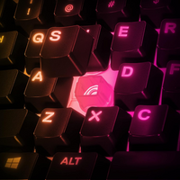 Close-up of a keyboard with glowing pink and orange letters on a dark background